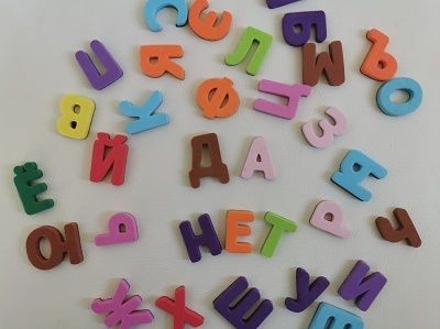 Russisches Alphabet in bunten Spielsteinen