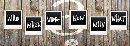 Holzzaun mit Fragen: Who, When, Where, How, Why, What