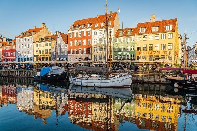 Fluss in Copenhagen vor bunter H&auml;userfront mit Segelboot