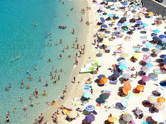 Strand in Italien mit vielen bunten Sonnenschirmen